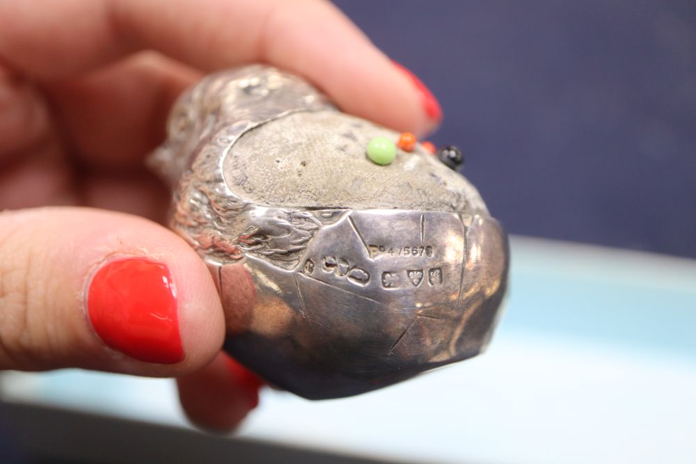 An Edwardian silver mounted hatching chick pin cushion, etc.